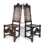 A pair of 18th century hall chairs with slat backs over solid seats and shaped aprons