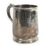 A George I silver tankard of plain bellied form with c-scroll handle on a circular foot,