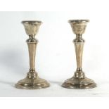 A pair of early 20th century silver dwarf candlesticks of typical form, makers marks indistinct,