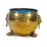 A 19th century brass scuttle with lion mask handles, exposed rivets and claw feet,