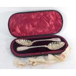 A cased pair of Victorian silver and parcel gilt fiddle pattern berry spoons,