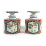 A pair of early 20th century Chinese bottles and stoppers, each decorated with blossoming branches,