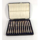 A cased set of twelve silver handled butter knives,