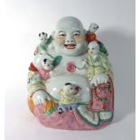 A Chinese figure modelled as the Buddha and five clambering children, h.