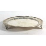 A Victorian silver miniature salver/card tray of circular form with gadrooned border on three shell