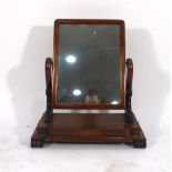 A Victorian mahogany swing mirror on a platform base with claw feet, w.