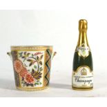 A Royal Crown Derby paperweight modelled as a champagne bottle together with the matching ice