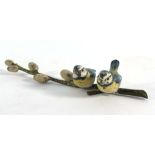 An early 20th century cold painted bronze figural group modelled as bluetits seated on a branch, l.