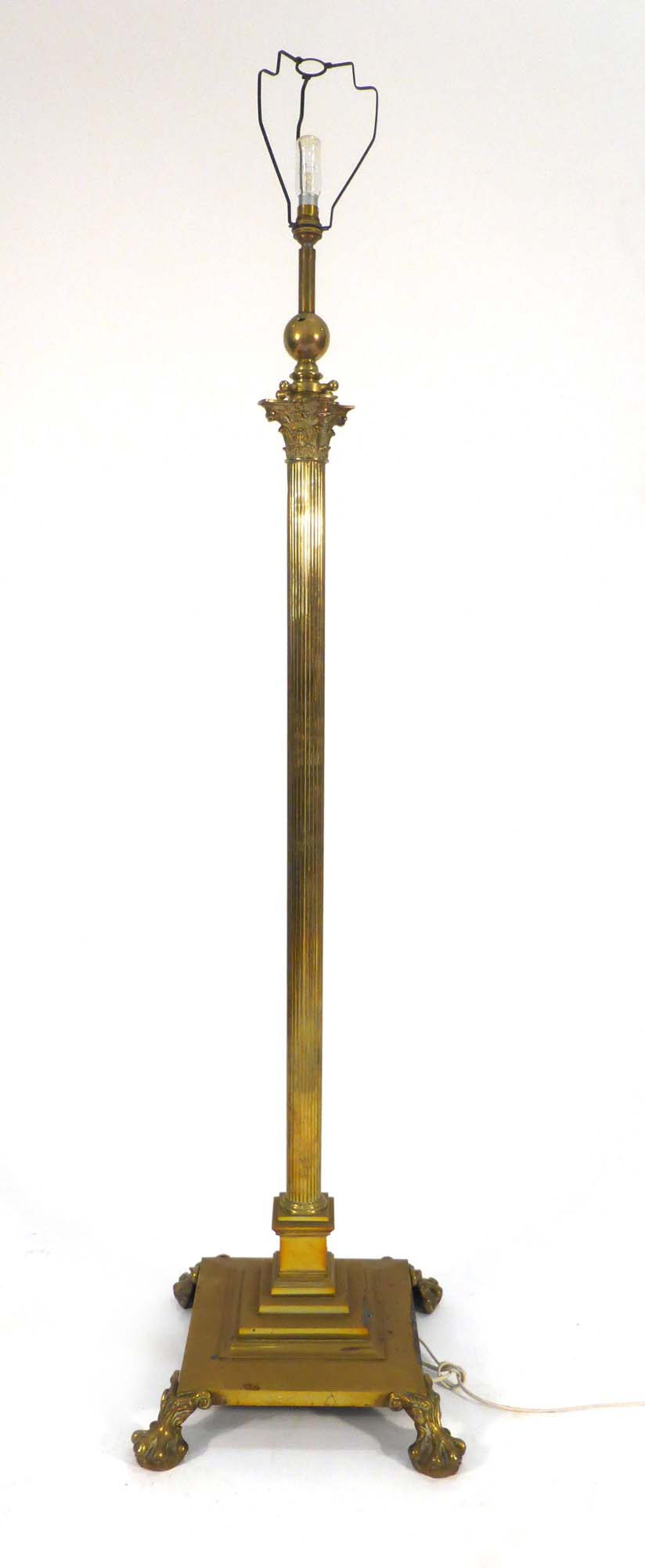 A Victorian brass adjustable standard lamp on a platform base with claw feet