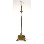 A Victorian brass adjustable standard lamp on a platform base with claw feet