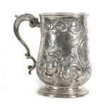 A George III silver tankard of bellied form with leaf capped c-scroll handle,
