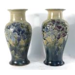 A pair of Royal Doulton tube-lined vases of baluster form decorated with flowering plants, h.
