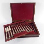 A Victorian mahogany and brass inlaid case containing eighteen silver handled dessert knives and