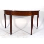 A George III mahogany D-end table, the plain frieze over four square tapering legs, w.