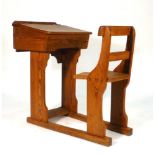 A Victorian pine integral school desk and elm seated chair,