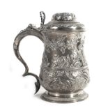 A George II silver and parcel gilt covered tankard of bellied form later decorated in the rococo