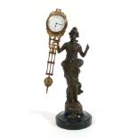 An early 20th century 'mystery' clock, the timepiece suspended by a bronze figure on a plinth base,