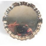 An early 20th century miniature silver salver/card tray of circular form with piecrust border on