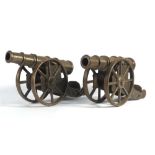 A pair of cast metal ornaments modelled as field cannon, registration 889867, l.