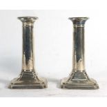 A pair of early 20th century silver dwarf candlesticks of tapered columnar form, maker TB&S,