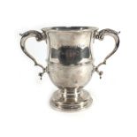 A George III silver two handled trophy vase of typical form having a pair of leaf capped c-scroll