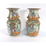 A pair of Cantonese vases of baluster form typically decorated in coloured enamels with court
