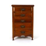 An Edwardian walnut five drawer music cabinet on tapering block feet, w.