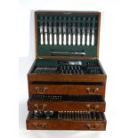 An oak canteen containing a twelve sitting silver service comprising: 12 x table knives and forks,