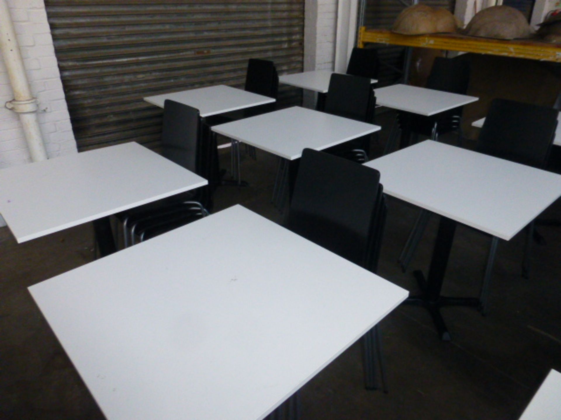 x white square-topped black metal pedestal tables, each with 4 black bentwood stacking chairs,