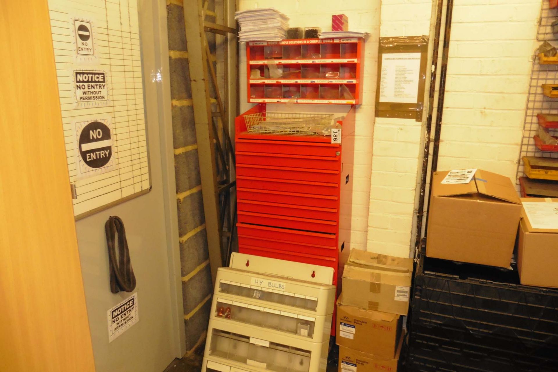 Red multi drawer unit containing nuts, bolts, washers, split pins, fuses, pipe fittings, etc