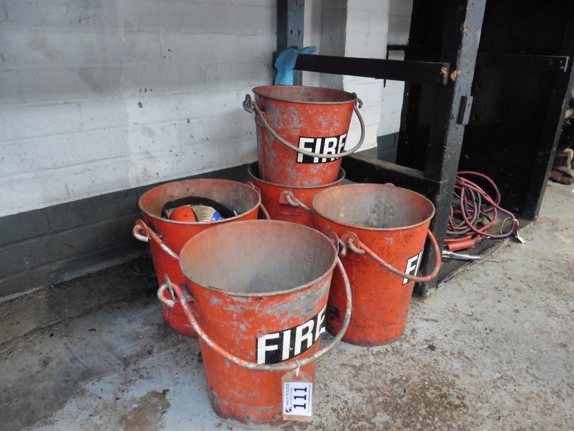 Five fire buckets and a range of brooms, crow bars etc