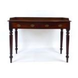 A William IV mahogany writing table, the galleried surface over two drawers on turned legs, w.