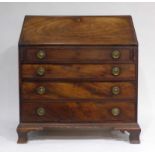 A George III mahogany bureau, the fall front over four long graduated drawers on bracket feet, w.