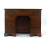 A George III and later mahogany kneehole desk,