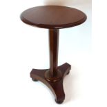 A 19th century mahogany occasional table, the circular surace on a turned column,