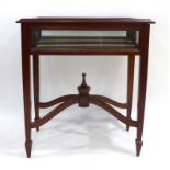 A reproduction mahogany bijouterie table on tapering legs joined by a cross stretcher, w.