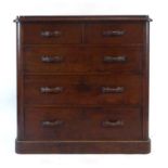 A Victorian mahogany chest of two short over three long drawers with unusual handles on a plinth