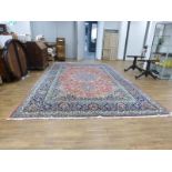 A Persian Mahal rug, the red ground with floral motifs within matching borders,