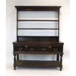 An 18th century and later oak dresser, the three tier graduated plate rack over two drawers,