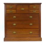 An Edwardian walnut chest of four short, one wide and three long graduated drawers on a plinth base,