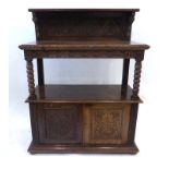 A Victorian carved oak sideboard with an exposed gallery over two solid doors, w.