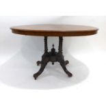 A Victorian walnut and inlaid looe table on four turned supports, platform base and scrolled feet,