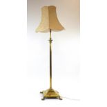 A Victorian brass telescopic standard lamp on a Neo-Classical column with a platform base and claw