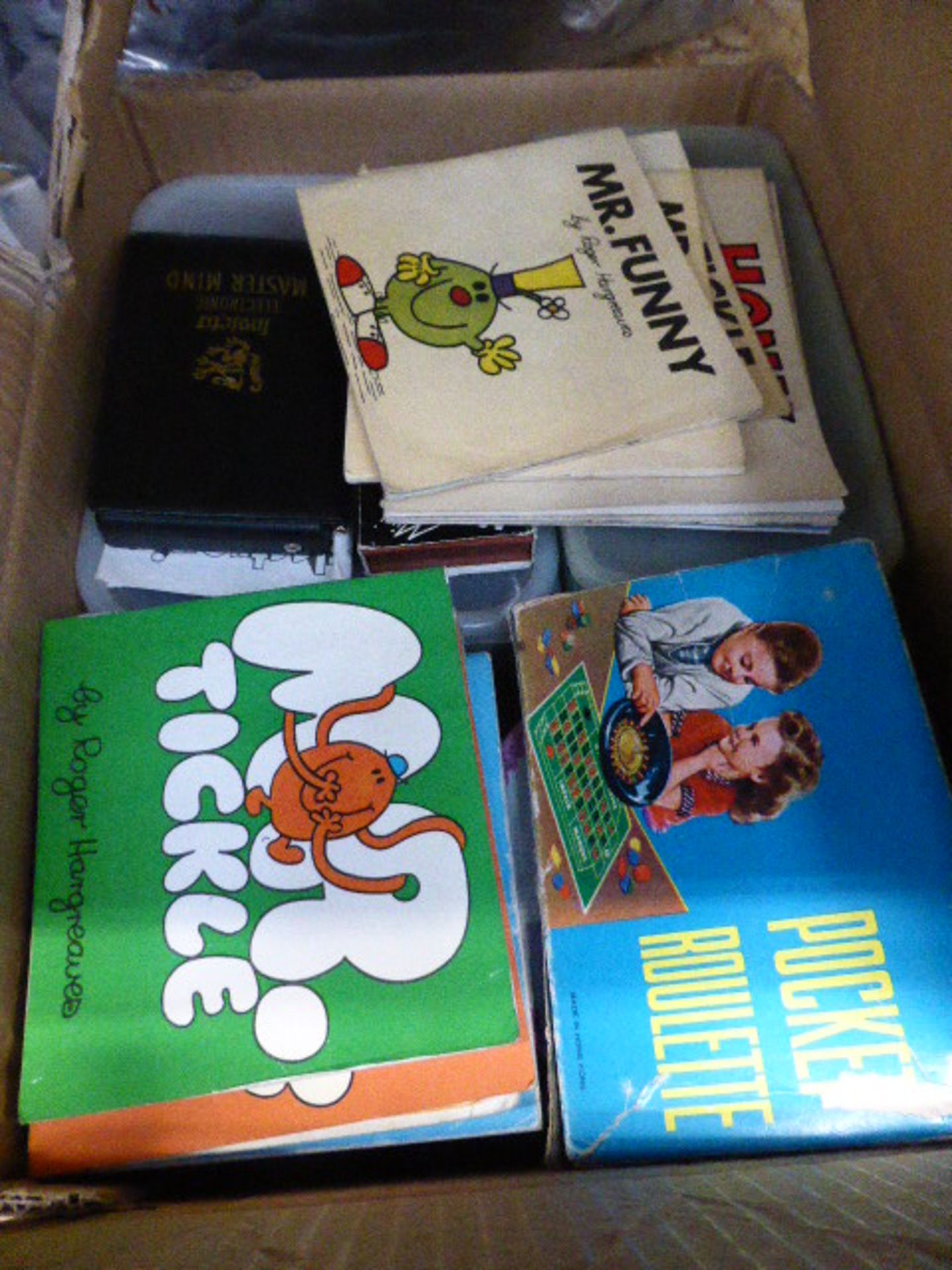 Quantity containing pocket roulette games, Mr Funny and Mr Tickle books, etc