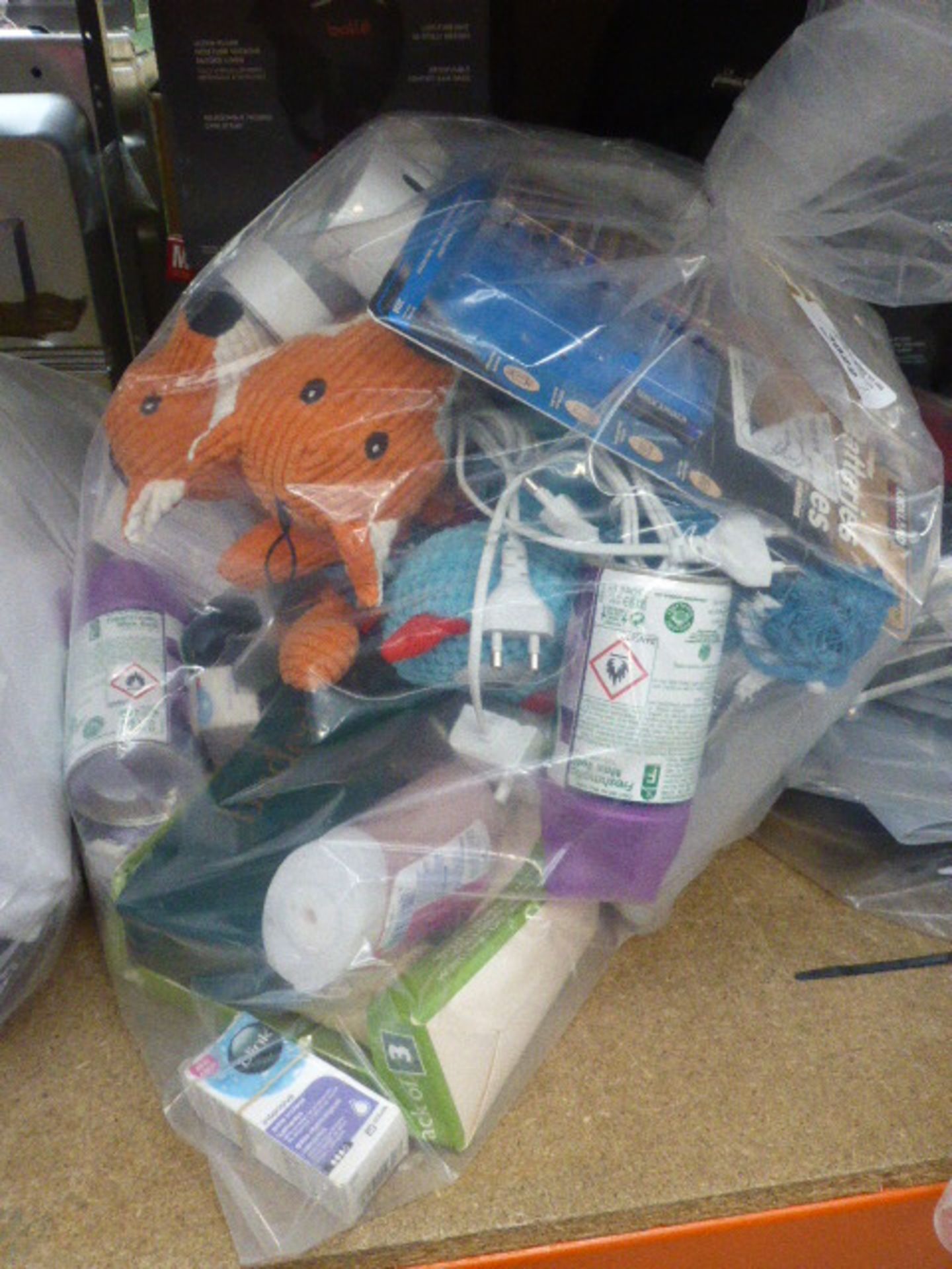 Bag containing some Kirkland batteries, Philips toothbrushes, dog toys, air fresheners, etc