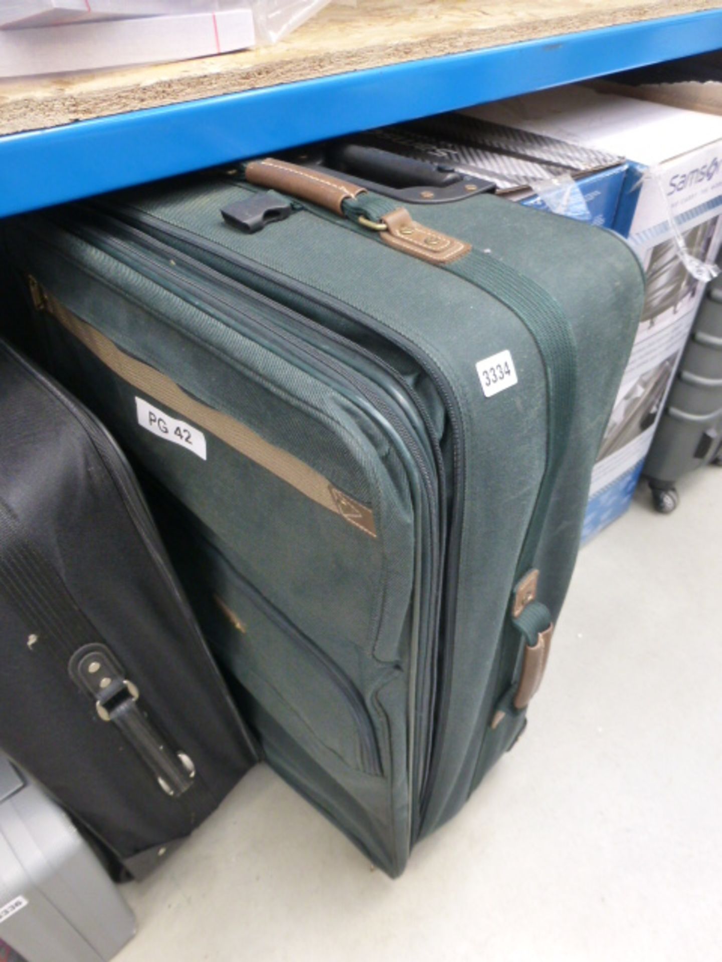 Large green fabric suitcase