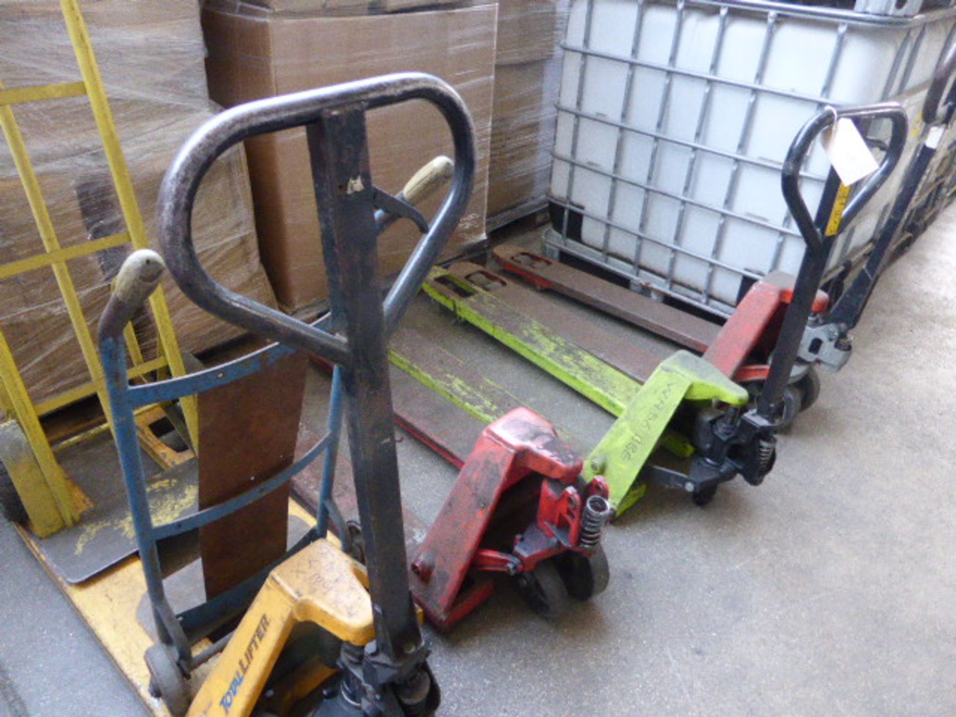 4 pallet trucks in various states of repair and 2 sack barrows in various state of repair