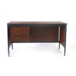 A 1960/70's teak desk, the suspended pedestal with three drawers, on metal tubular legs, w.