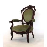 A Victorian mahogany and upholstered open armchair on scrolled front legs