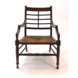 A 19th century mahogany open armchair with turned legs and stretchers,